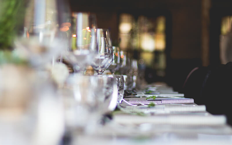 Glasses neatly arranged in a line on a dining table